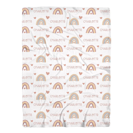 a blanket with hearts and rainbows on it